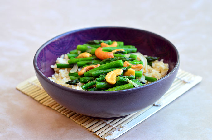 Asparagus and Cashew Stir-fry with tender-crisp asparagus and crunchy cashews served over nutty brown rice. A vegan dish that's as nutritious as it is delicious!