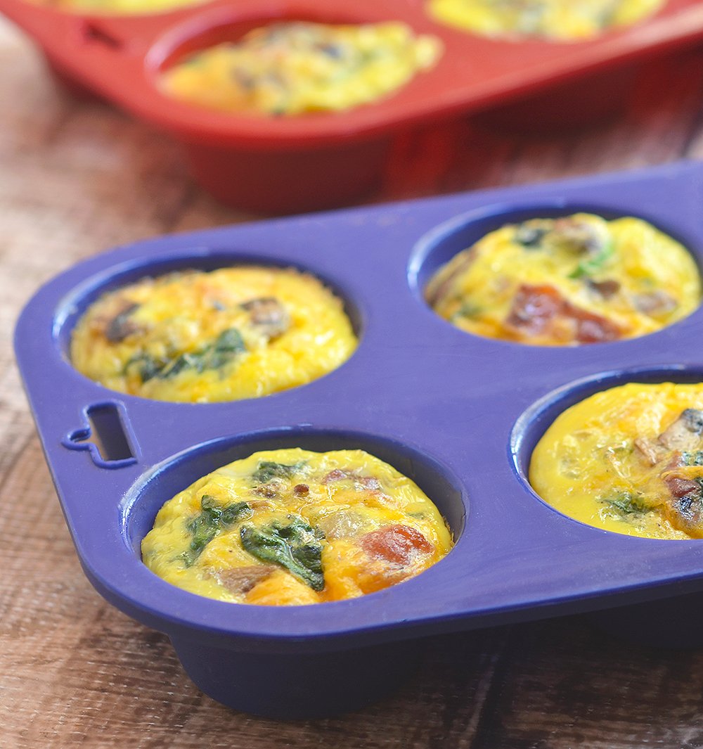 Bacon Spinach and Mushroom Egg Muffins loaded with crisp bacon, meaty mushrooms, and baby spinach. An excellent source of protein and full of healthy veggies, these portable mini frittatas are nutritious as they are delicious!