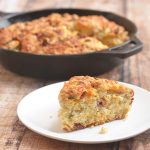 Skillet Cheddar-Bacon Beer Bread is a savory quick bread with smoky bacon, sharp cheddar, and green onions. Golden and crisp on the outside and moist and fluffy on the inside, it's the perfect pair to your favorite hearty soup or homemade chili.