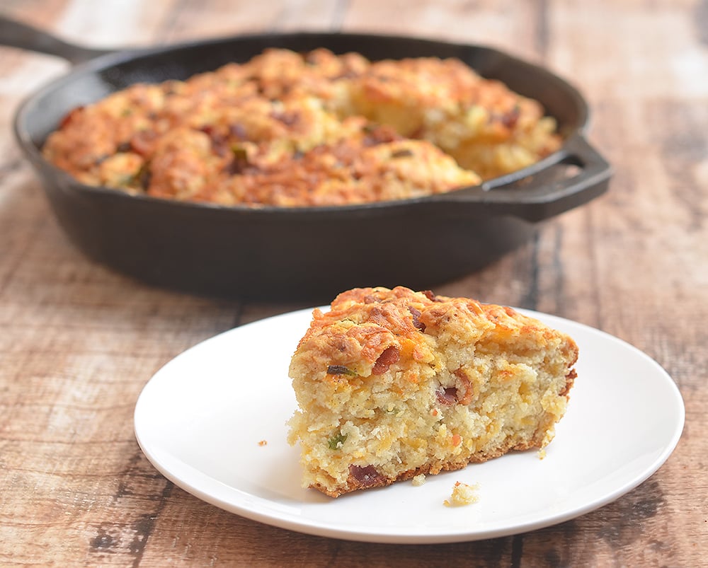 Skillet Cheddar-Bacon Beer Bread is a savory quick bread with smoky bacon, sharp cheddar, and green onions. Golden and crisp on the outside and moist and fluffy on the inside, it's the perfect pair to your favorite hearty soup or homemade chili.