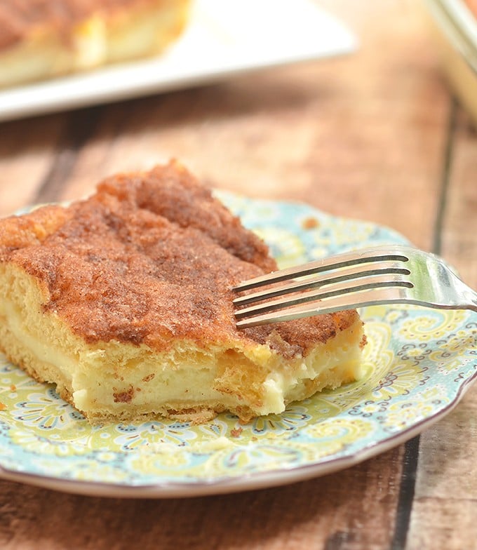 Sopapilla Cheesecake Bars with pillowy, cinnamon pastry and dreamy cheesecake layer are ridiculously easy to make yet absolutely delicious. Make sure to double the batch as your guests will be lining up for more!