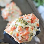 serving baked salmon with a spatula from a baking sheet.