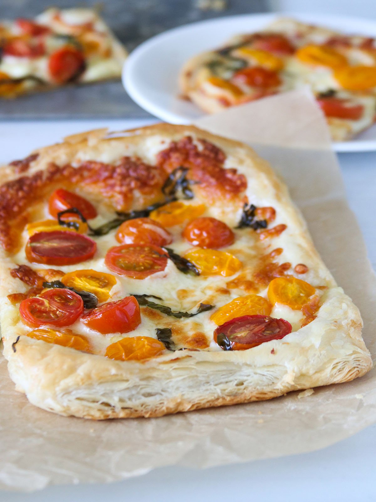 freshly baked Puff Pastry Margherita Pizza on a parchment paper