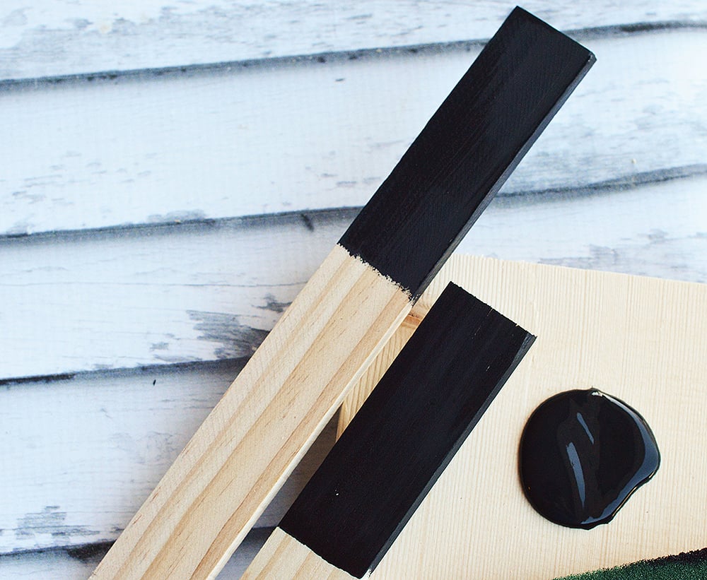 DIY Chalkboard Garden Markers make a cute addition to your garden! Made with sturdy wooden stakes and painted black chalkboard paint, they're reusable year after year!