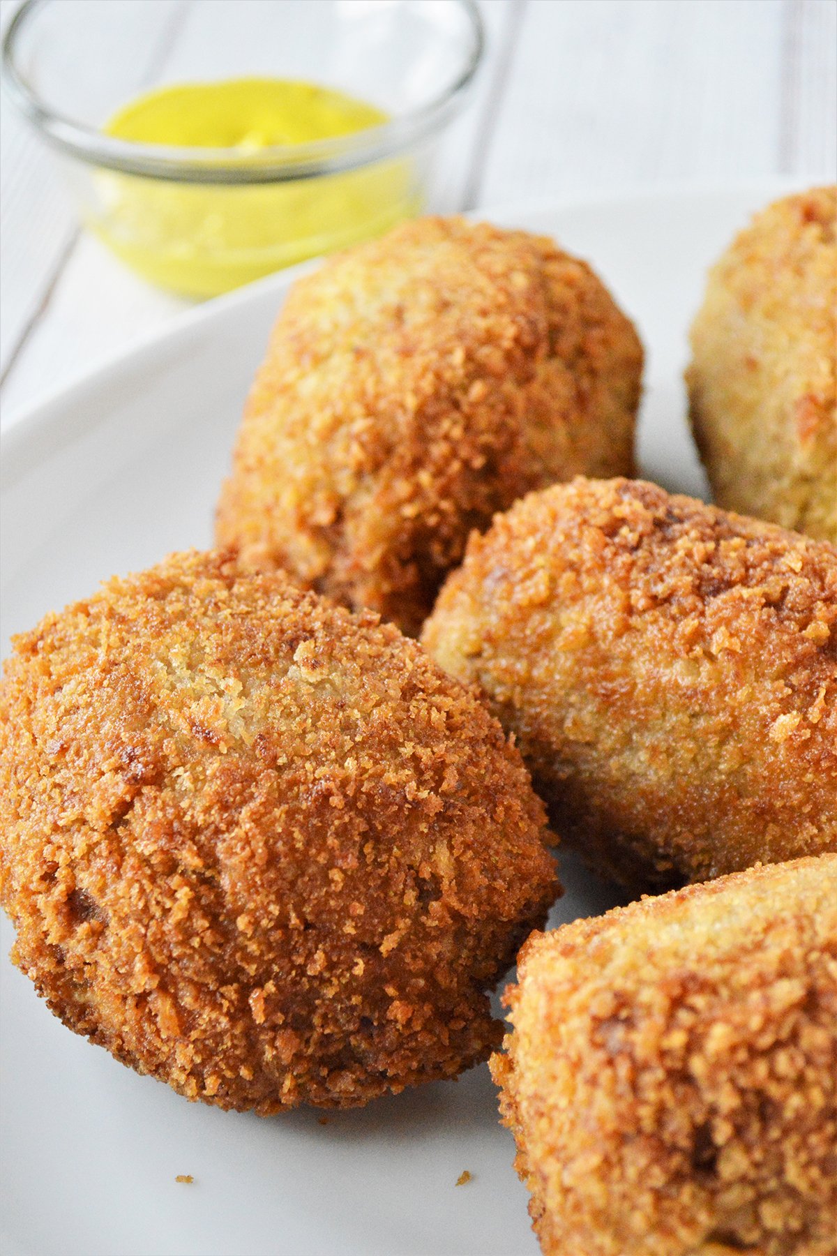 crispy breaded picnic eggs on a white plate