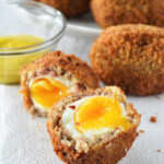 halved scotch eggs on a napkin