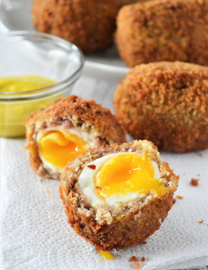 halved scotch eggs on a napkin