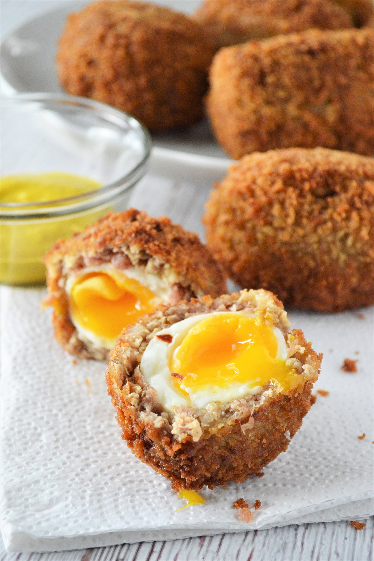 halved scotch eggs on a napkin