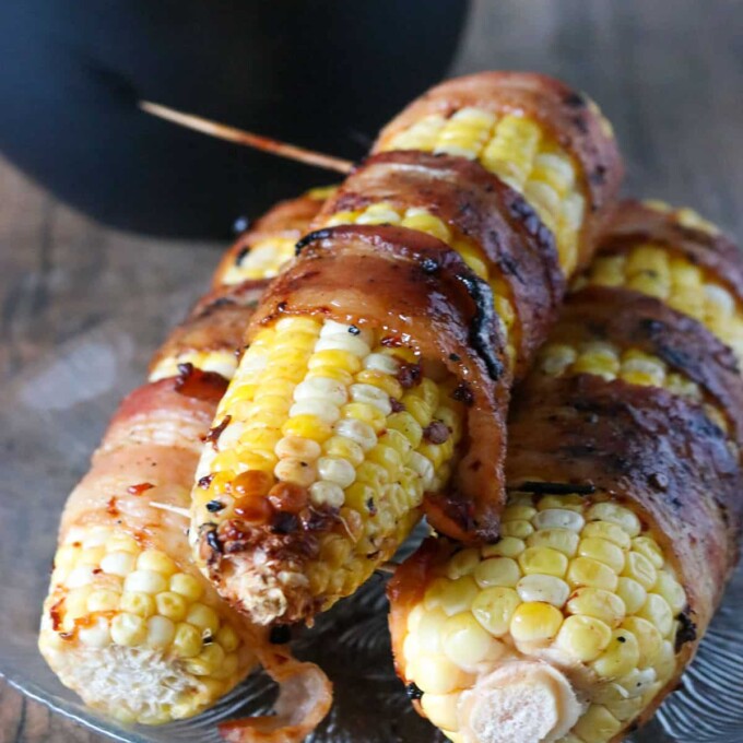 Bacon-Wrapped Corn with Chipotle Honey Glaze on a serving plate.