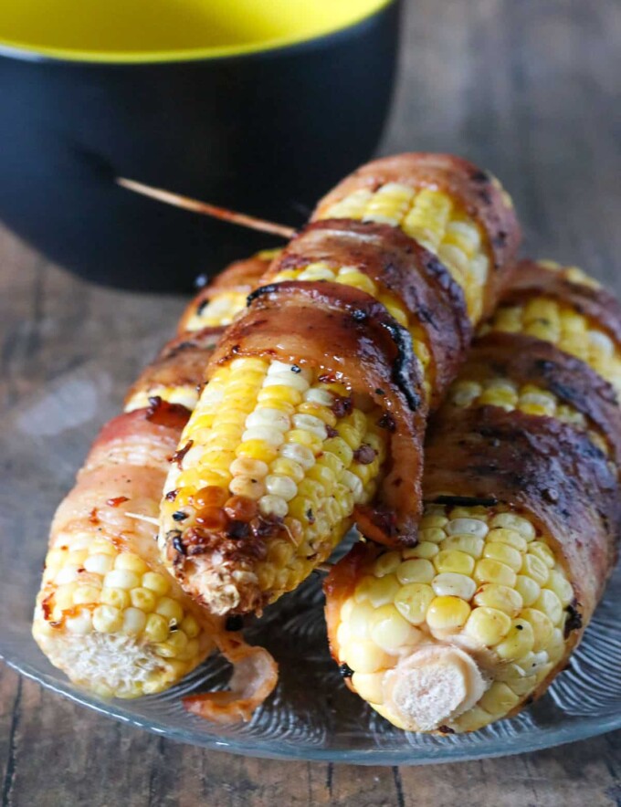 Bacon-Wrapped Corn with Chipotle Honey Glaze on a serving plate.