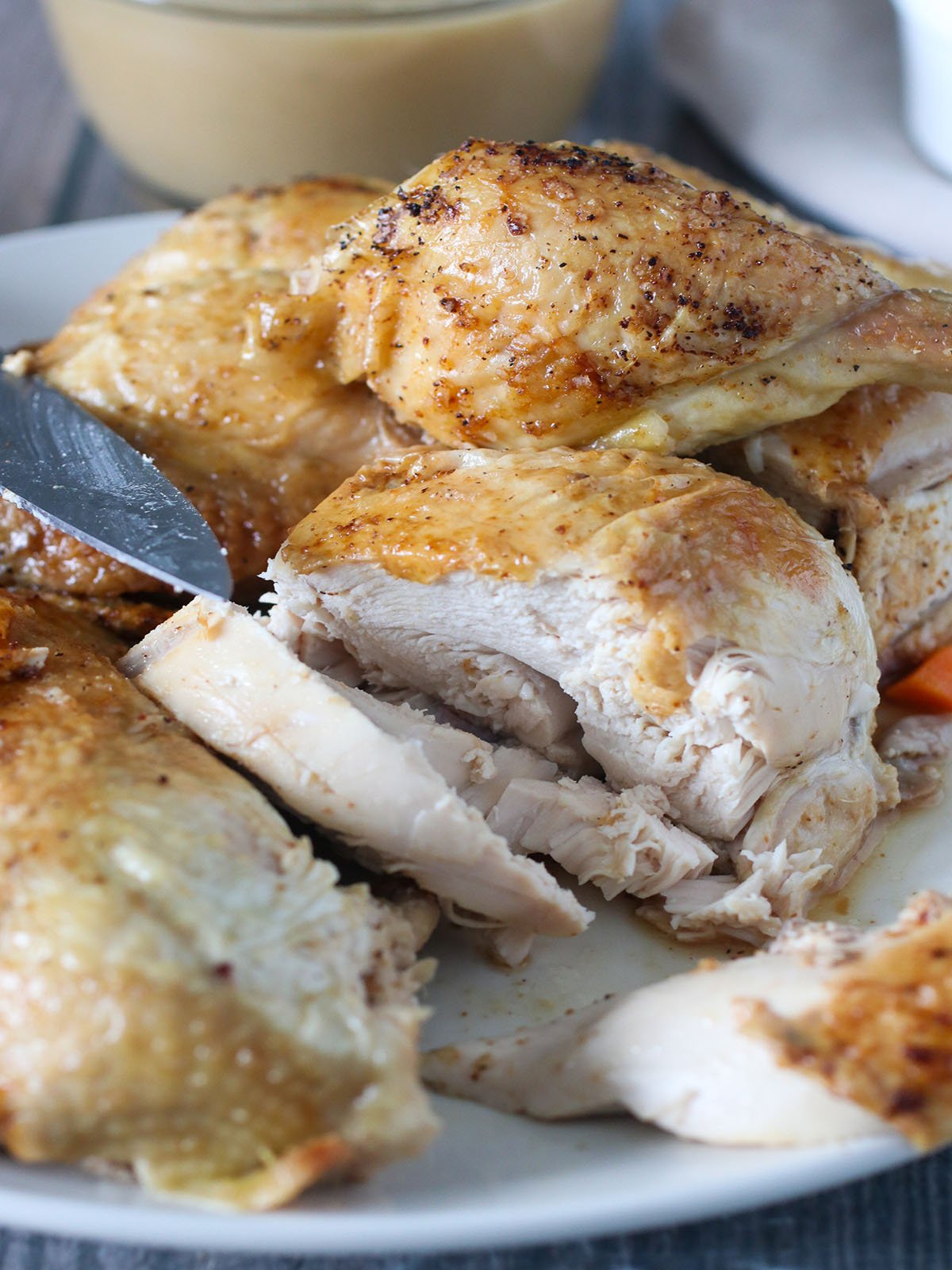 sliced roasted chicken on a white platter