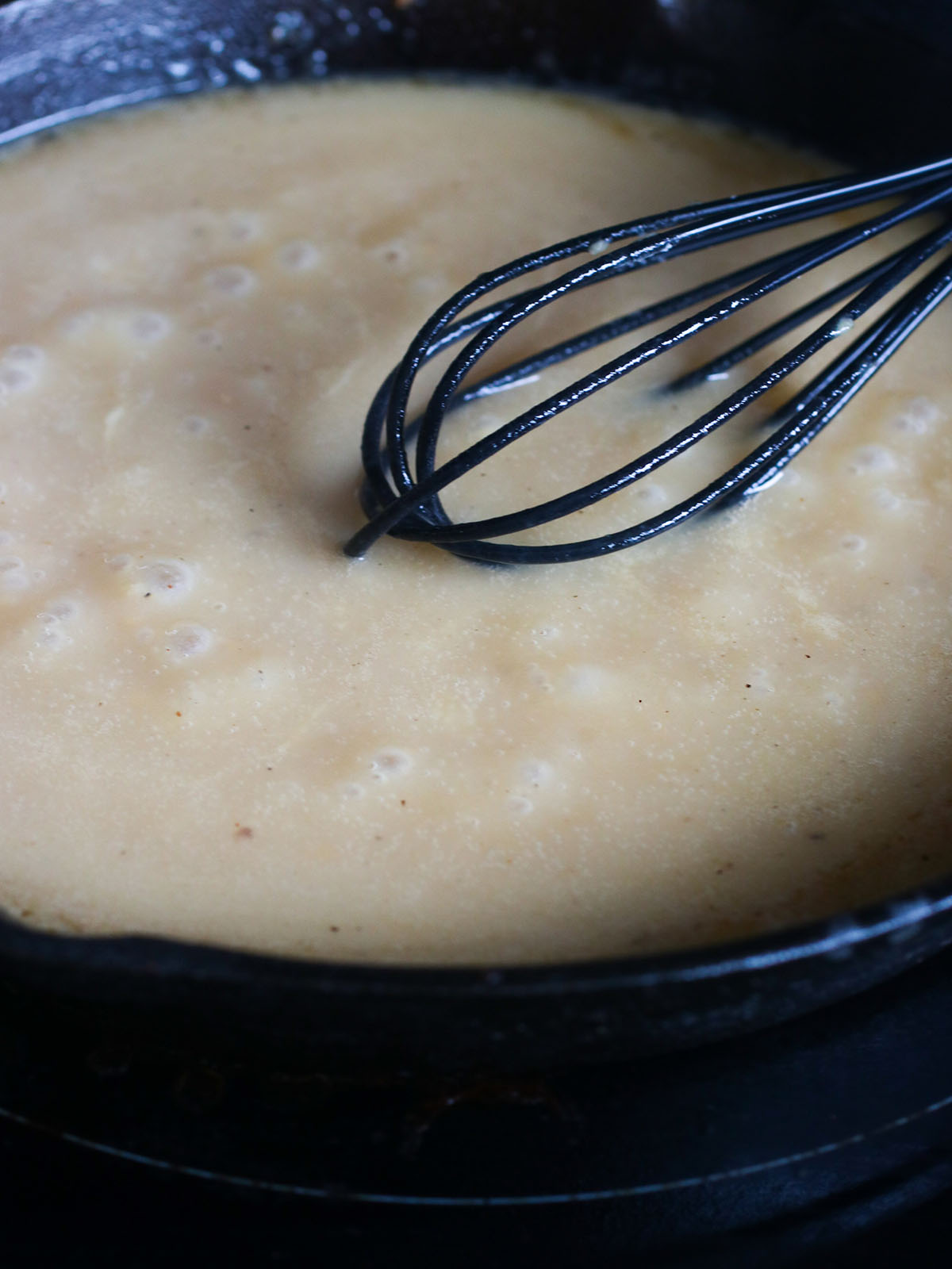 making gravy from pan drippings in a cast iron