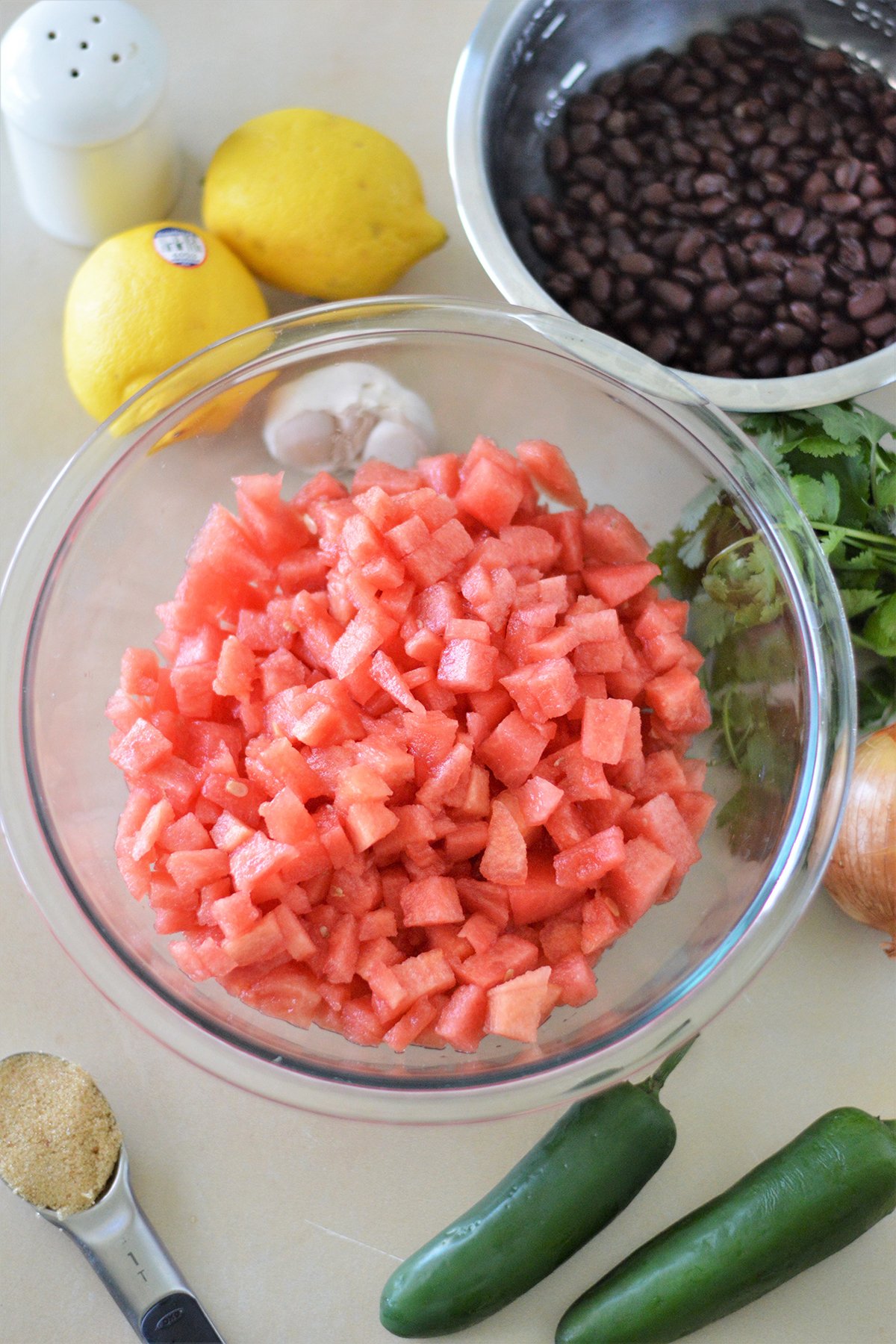 diced watermelon, black beans, lemon, cilantro, onions, garlic, jalapenos, brown sugar, salt