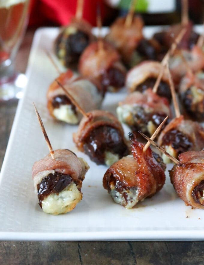 Brown Sugar Devils on Horseback on a white serving platter