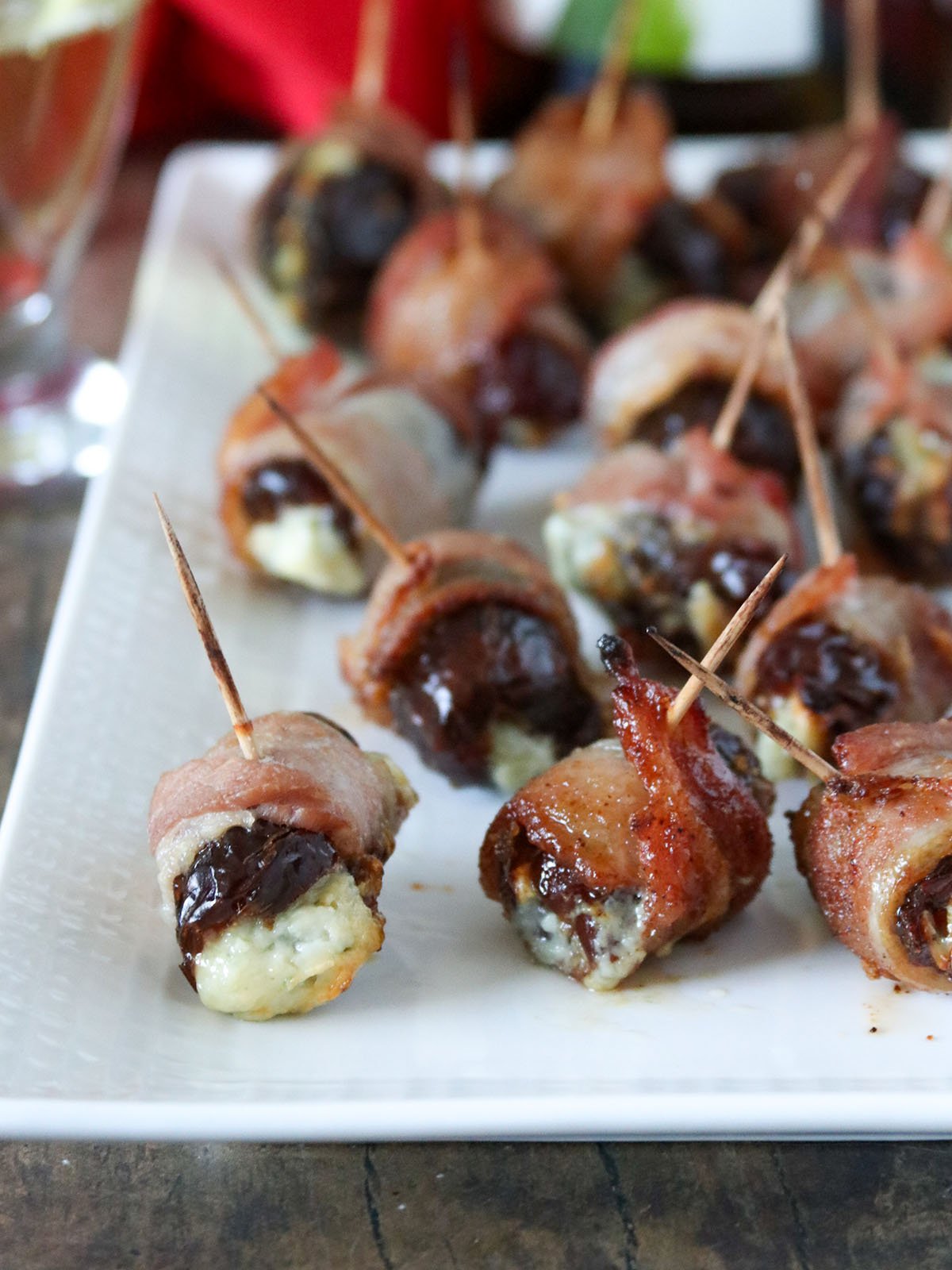 Brown Sugar Devils on Horseback on a white serving platter