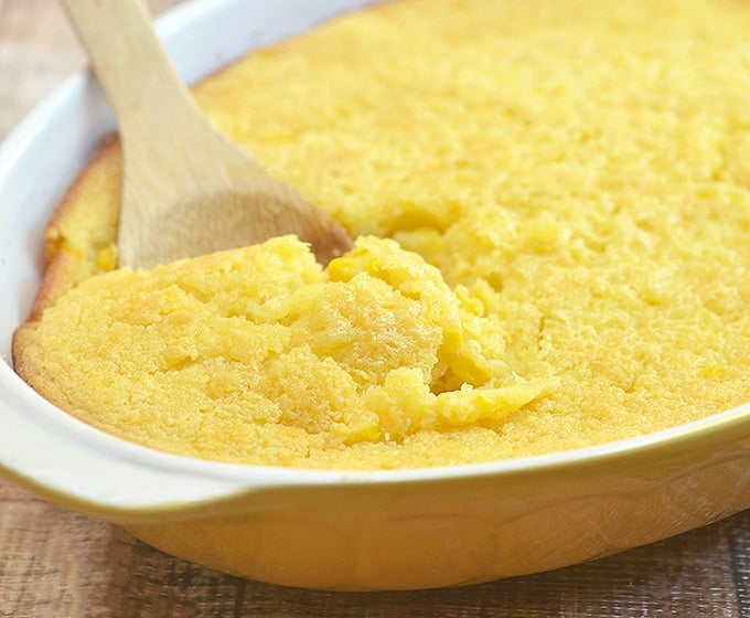 sweet corn spoonbread in a yellow casserole dish