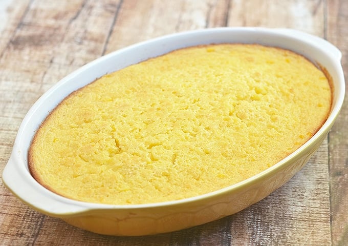 Sweet Corn Pudding baked in a yellow casserole dish