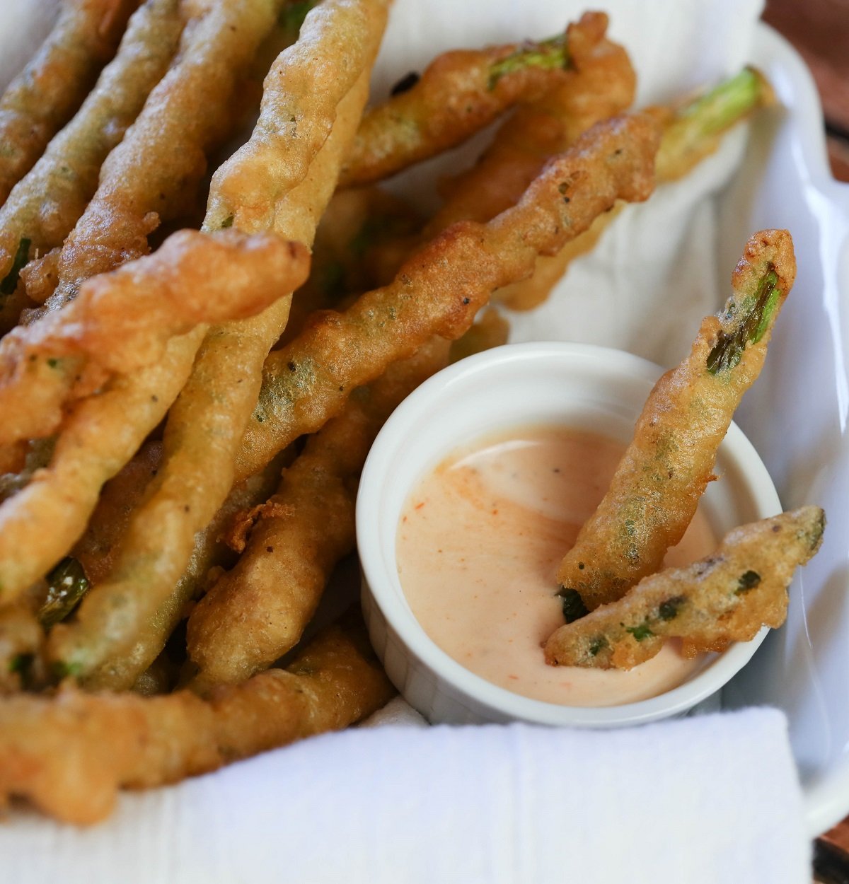 battered asparagus dipped in sauce