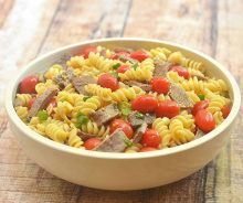 pasta salad with Mongolian beef, tomatoes, green onions