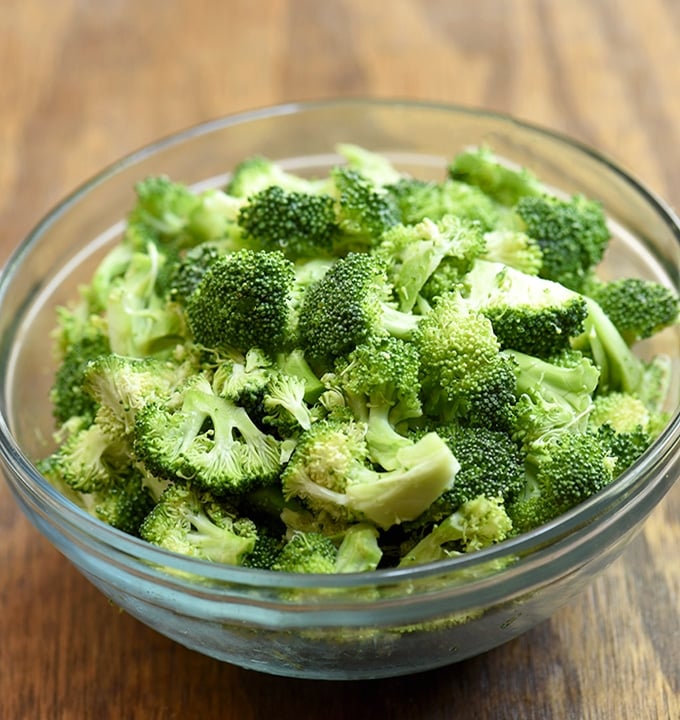 chopped fresh broccoli in a clear glass bowl