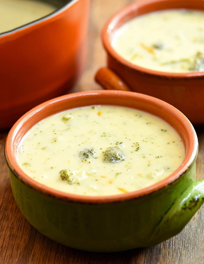 broccoli and cheese soup in a green ceramic bowl