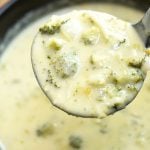 servng broccoli cheese soup from pot with a soup ladle