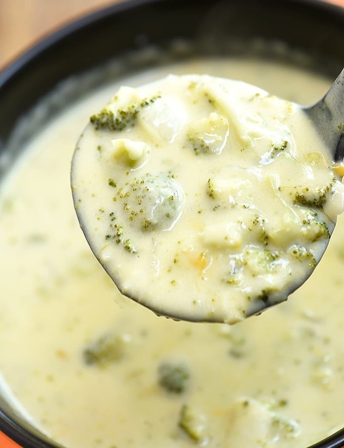 servng broccoli cheese soup from pot with a soup ladle