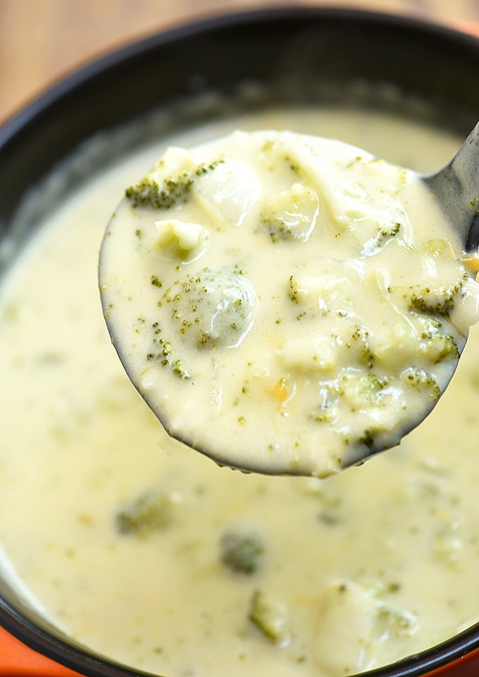 servng broccoli cheese soup from pot with a soup ladle