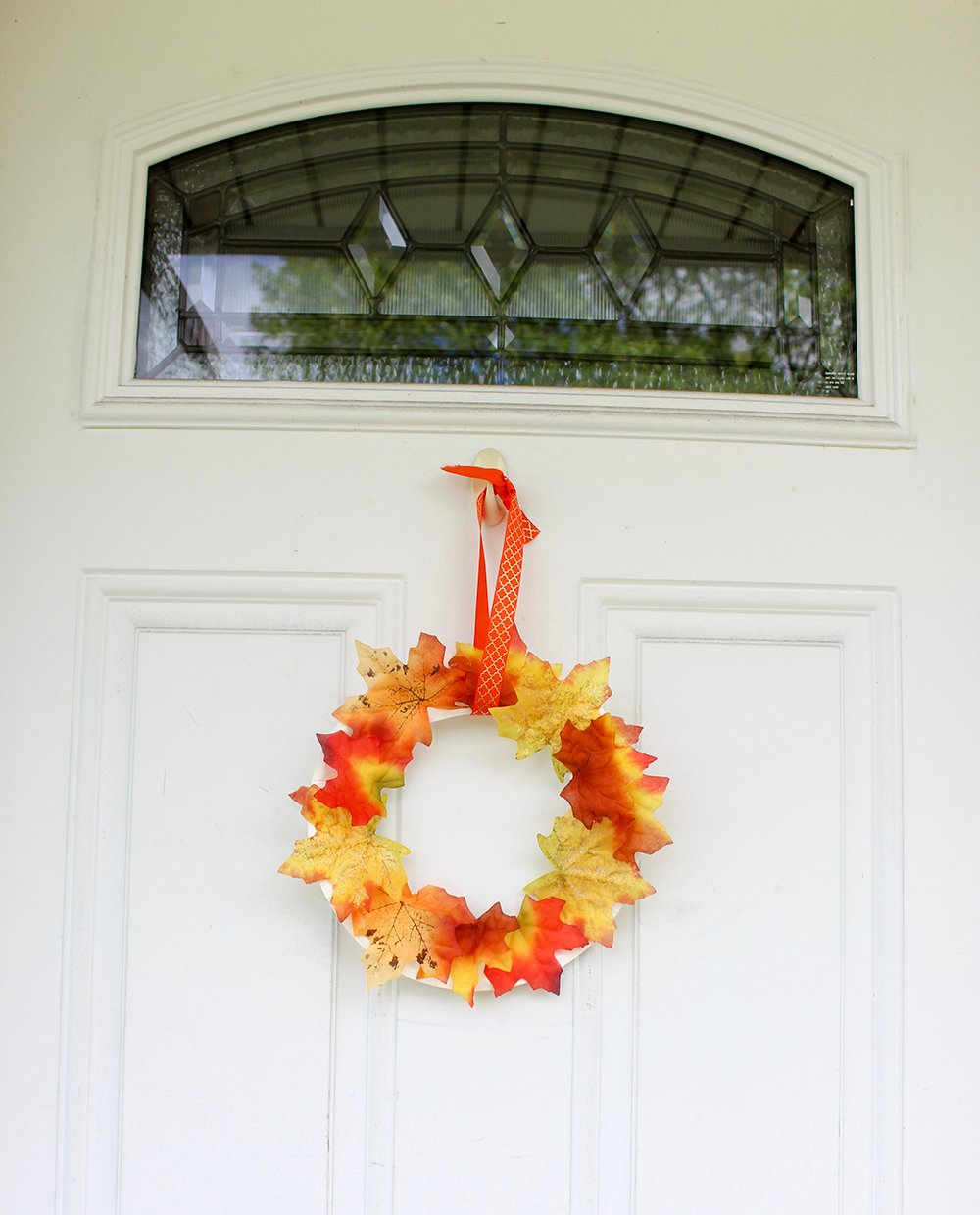 DIY Fall Wreath to easily spruce up your home and add Autumn colors to your decor. It's quick and fun to make with the kids from Dollar Store supplies!