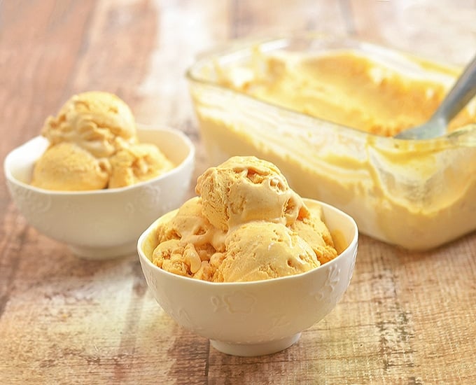 scoops of pumpkin ice cream in white bowls