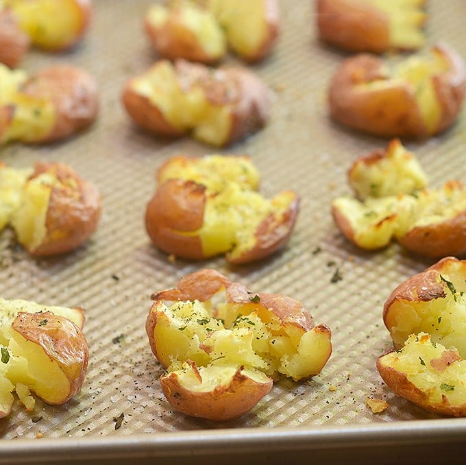 Parmesan Smashed Potatoes are fluffy on the inside and crispy on the outside for a seriously addicting side dish. They might not be the prettiest spuds on the block but they sure are one of the tastiest!