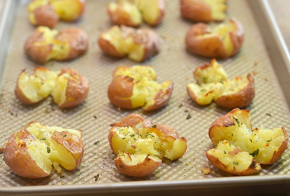 Parmesan Smashed Potatoes are fluffy on the inside and crispy on the outside for a seriously addicting side dish. They might not be the prettiest spuds on the block but they sure are one of the tastiest!