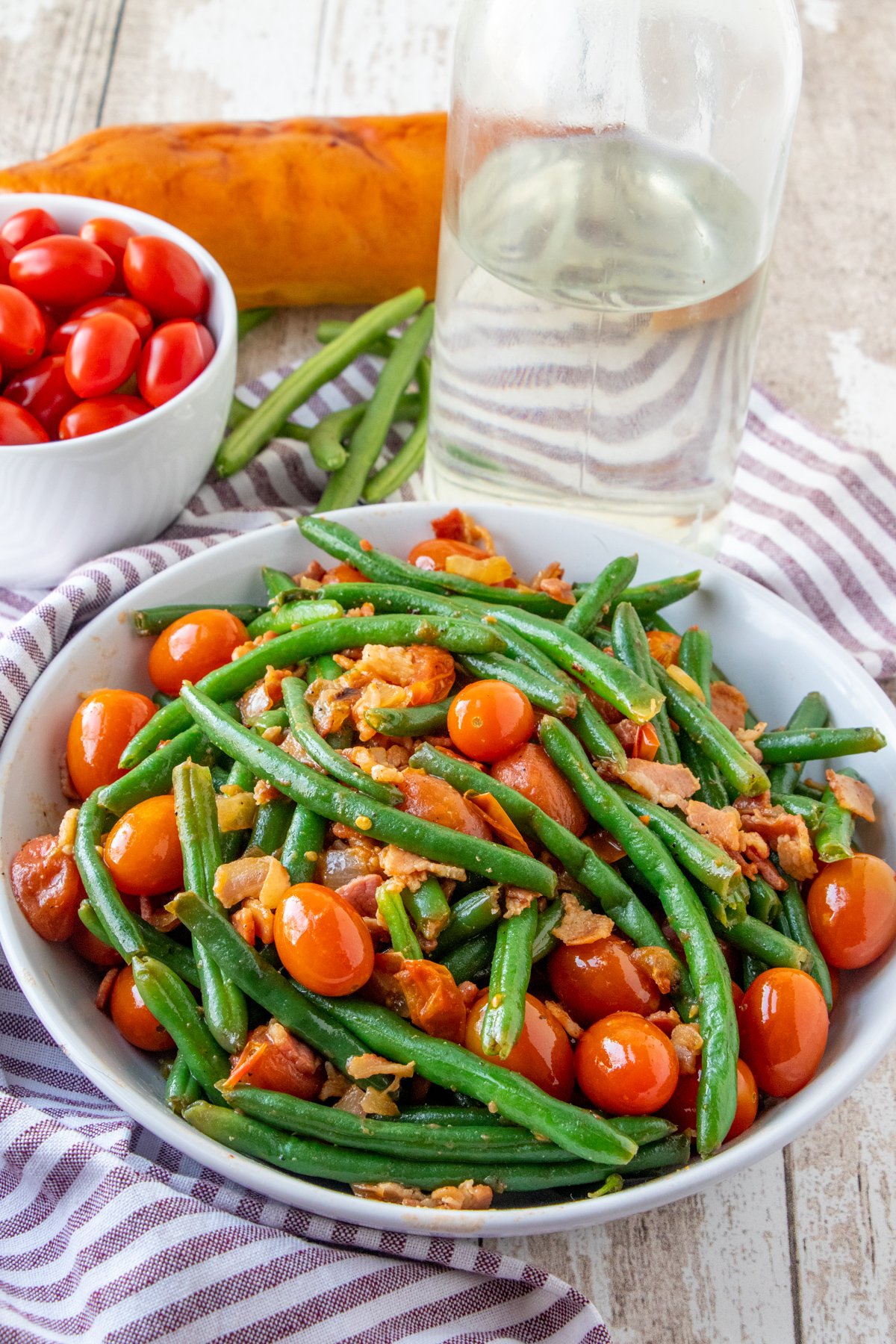 Green Beans with Bacon and Tomatoes in a white serving bowl