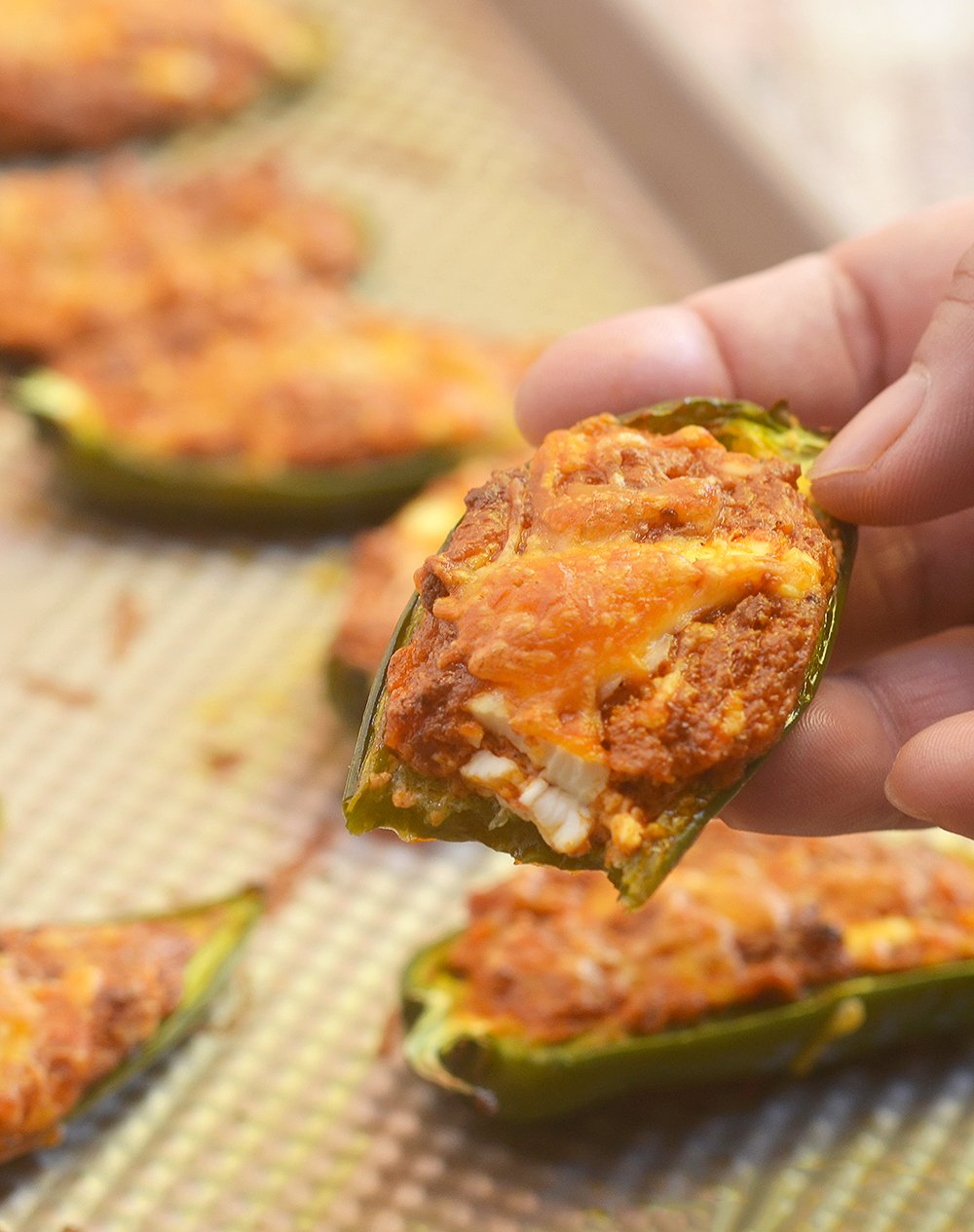 Mexican-style Jalapeno Poppers filled with crumbled chorizo, cream cheese, and shredded cheddar. They're spicy, creamy, and absolutely addicting!