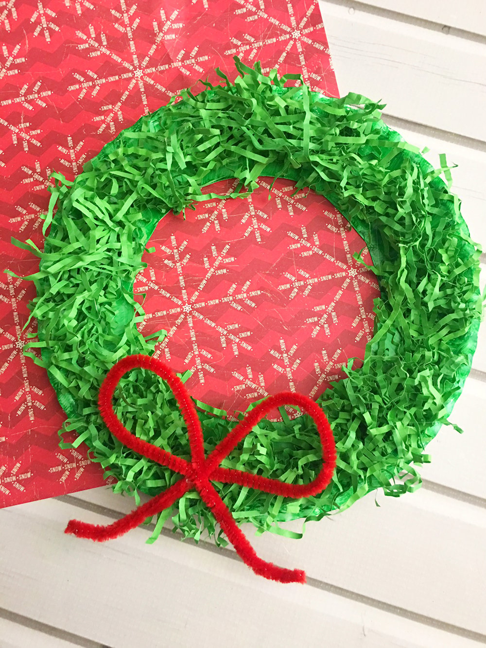 DIY Paper Christmas Wreath is a fun paper craft to do with the whole family. It's inexpensive to make and adds a festive touch to your holiday decor.