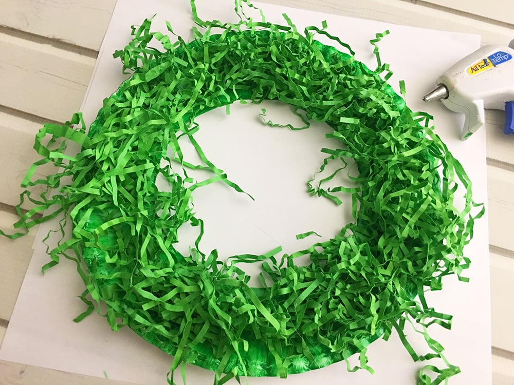 DIY Paper Christmas Wreath made with paper plate and shredded crinkle paper adds a festive touch to your holiday decor-glue shredded crinkle paper to paper plate circle to cover