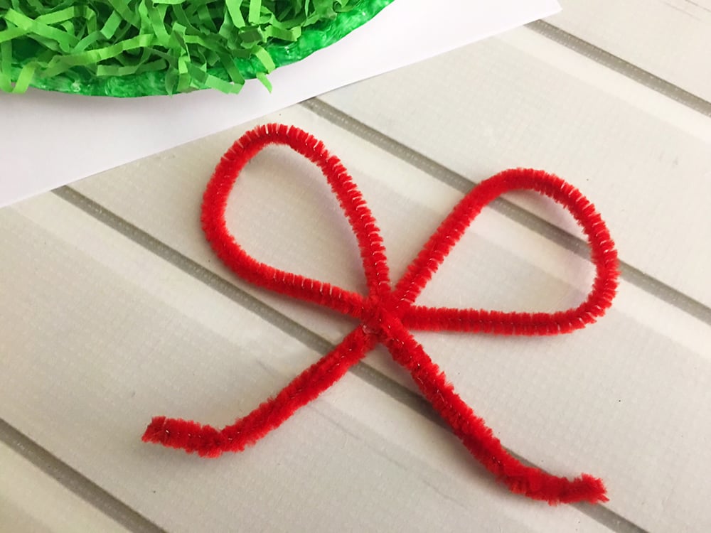 DIY Christmas Paper Wreath is a fun paper craft to do with the whole family. It's inexpensive to make and adds a festive touch to your holiday decor-glue pipe cleaner loops together to form a bow