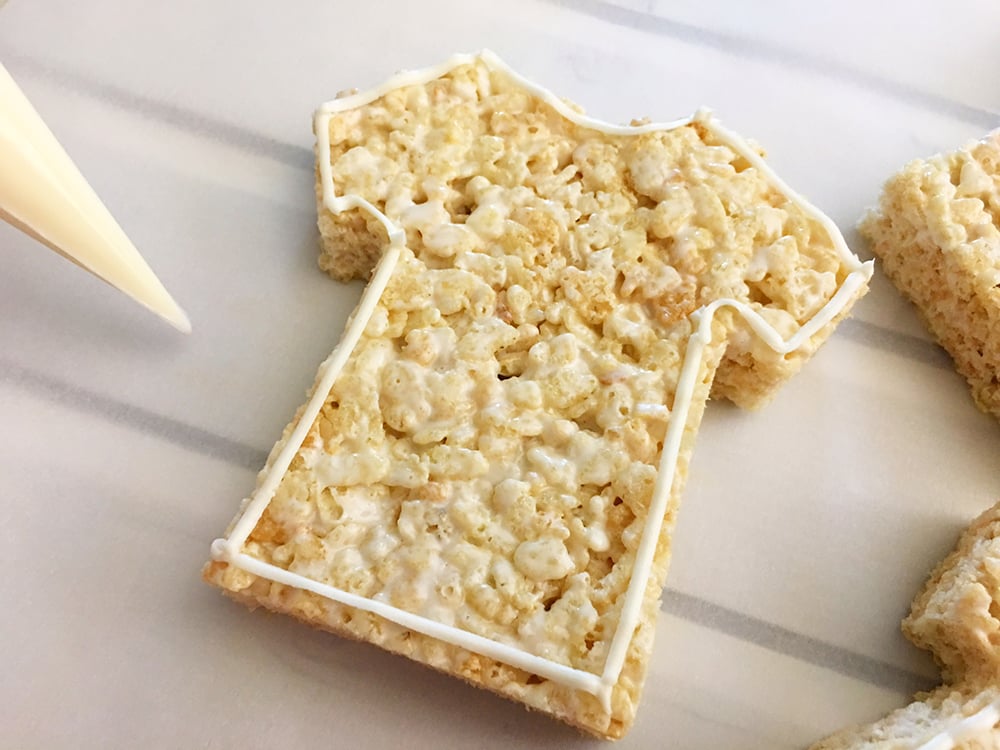 Use vanilla frosting to outline the jersey shape of these cute rice crispy treats. 
