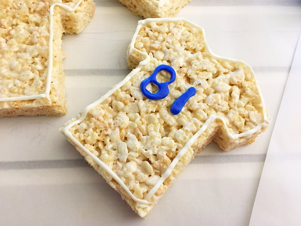 Put the fondant numbers on the front of each rice crispy jersey. 