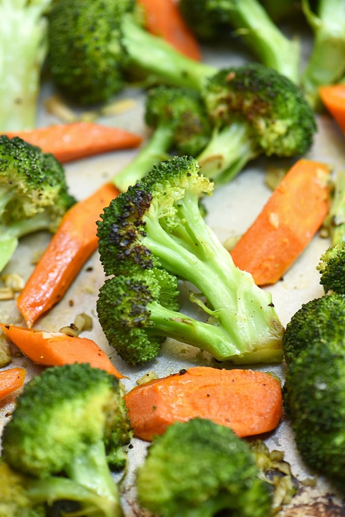 oven-roasted broccoli and carrots with garlic on a baking sheet