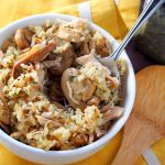 serving Instant pot rice casserole with chicken and mushrooms from a white bowl