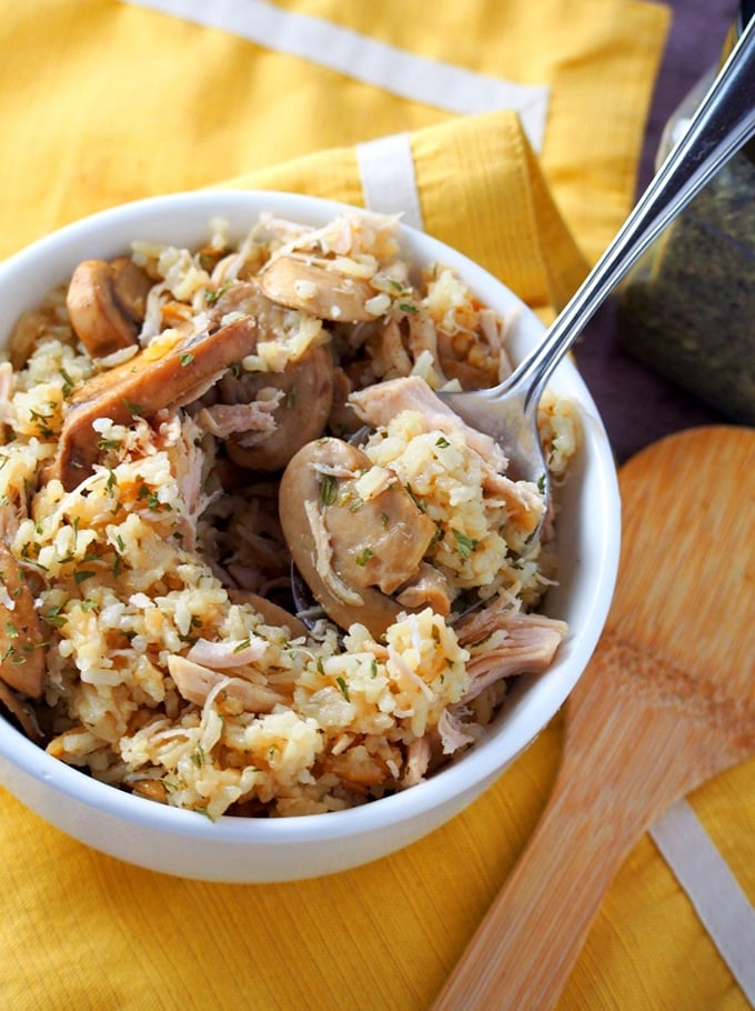 serving Instant pot rice casserole with chicken and mushrooms from a white bowl