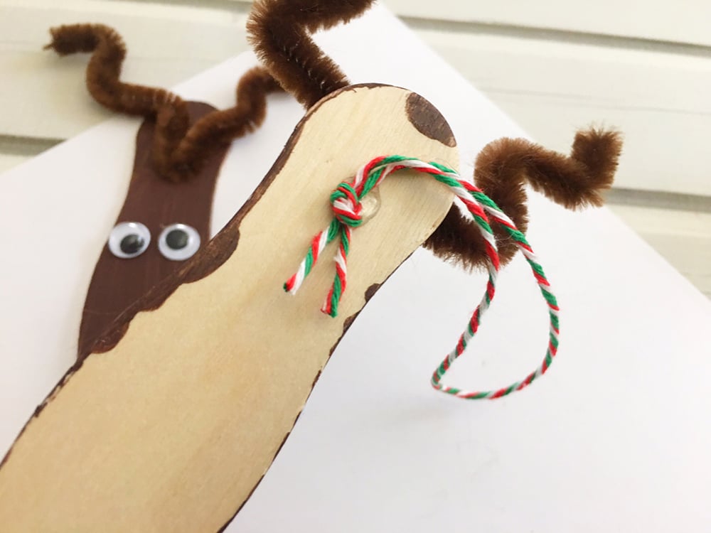 tie a twine into a loop and glue at the back of the craft sticks to hang the reindeer ornament