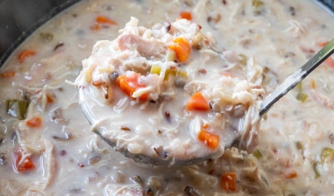 serving chicken and wild rice soup from the slow cooker