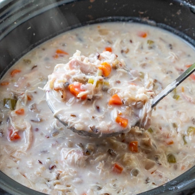 serving chicken and wild rice soup from the slow cooker