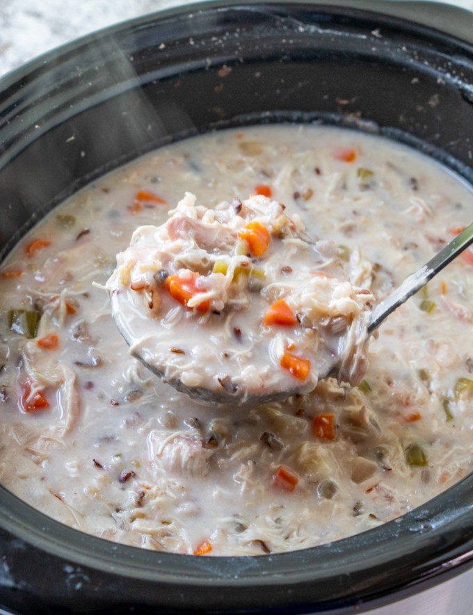 serving chicken and wild rice soup from the slow cooker