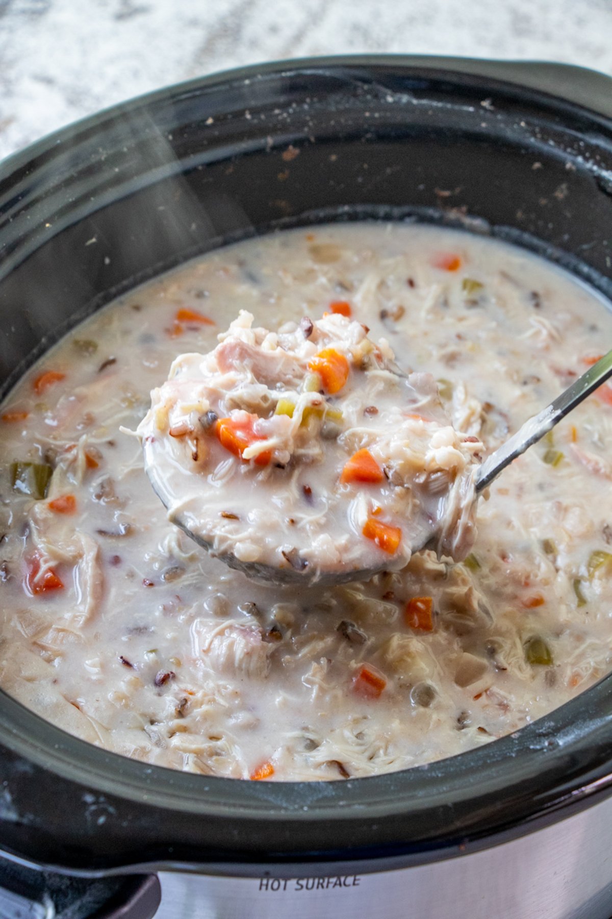 serving chicken and wild rice soup from the slow cooker