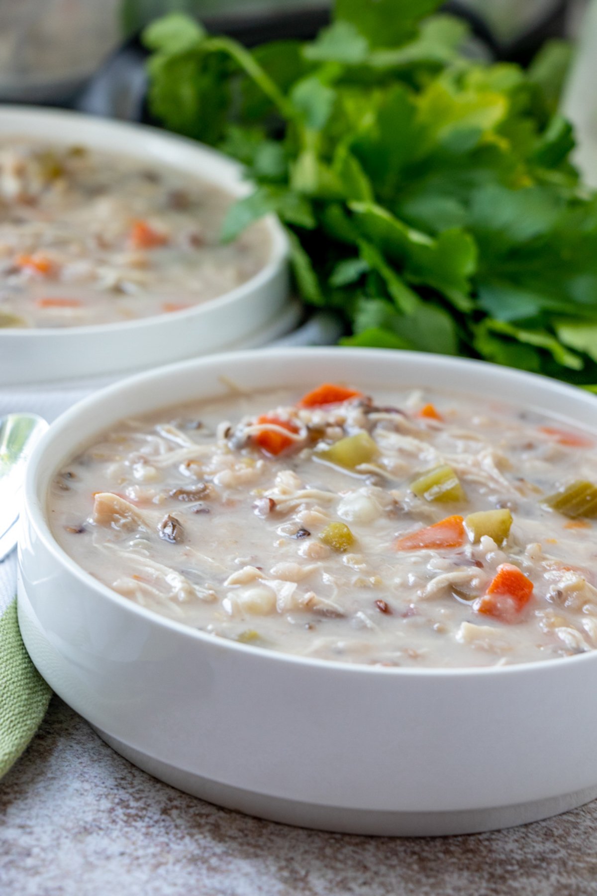 creamy chicken wild rice soup in white bowls