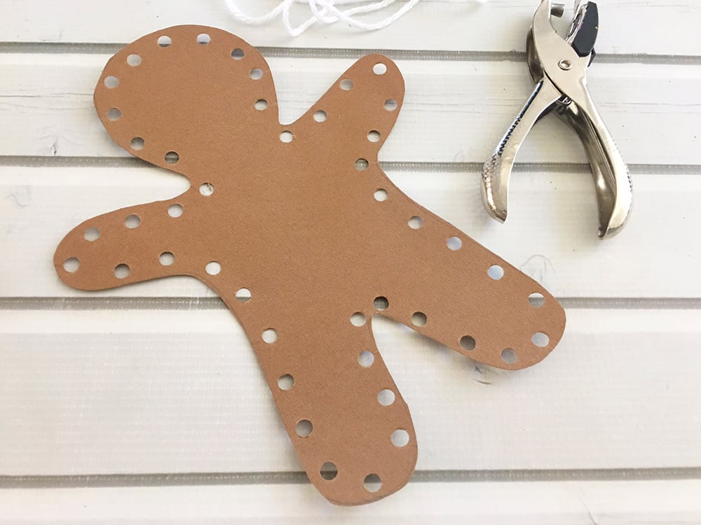 DIY Gingerbread Man Ornaments - punch holes along the outside of gingerbread man