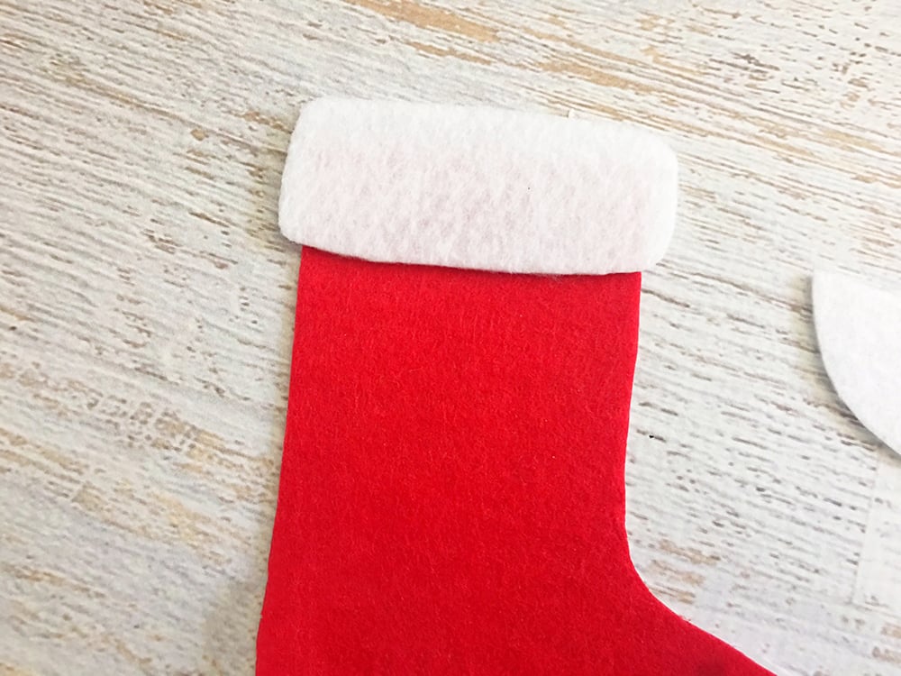 Felt Stocking Christmas Ornaments are an adorable addition to any holiday decor. So easy and fun to make with simple crafts supplies-glue white felt on top part of the red felt stocking